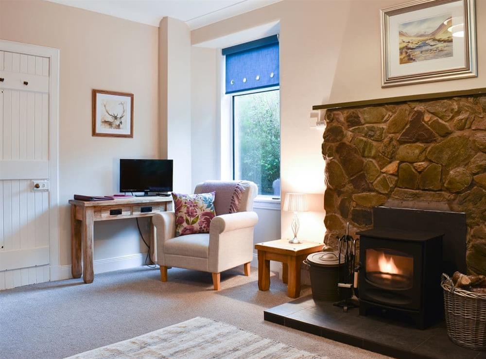 Sitting area in the dining room by the log burner at Ingleside in Whiting Bay, Isle of Arran, Scotland