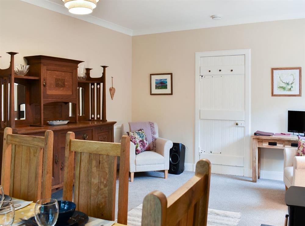 Spacious dining room with dresser at Ingleside in Whiting Bay, Isle of Arran, Scotland