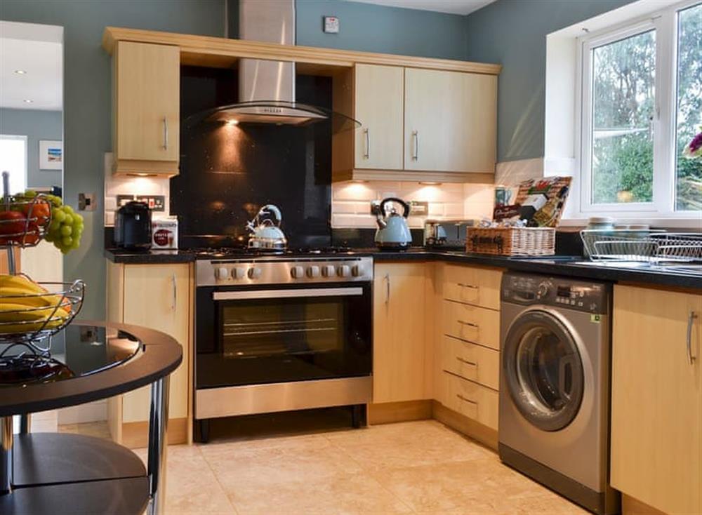 Fitted kitchen with breakfast area at Inland View in Trearddur Bay, near Holyhead, Anglesey, Gwynedd