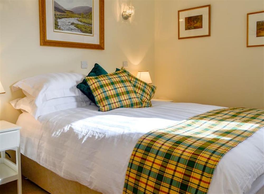 Relaxing bedroom with kingsize bed at The Old Inverchroskie Kennels, 