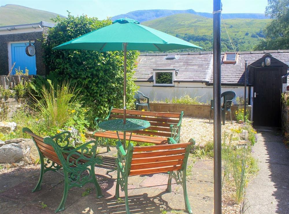 Enclosed garden with patio and furniture at Isallt in Nantlle, near Beddgelert, Gwynedd
