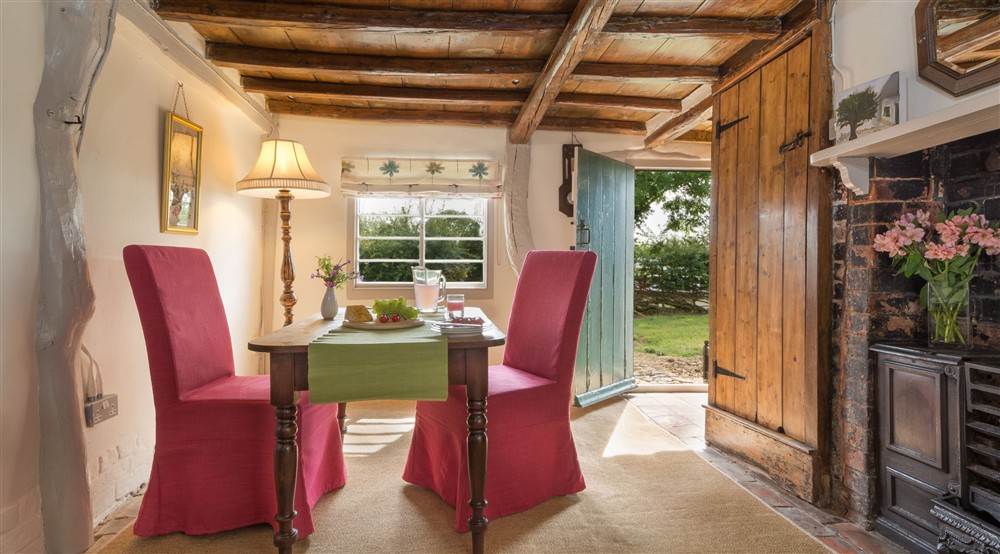The dining room, with original beams, at Itteringham Manor in Aylsham, Norfolk