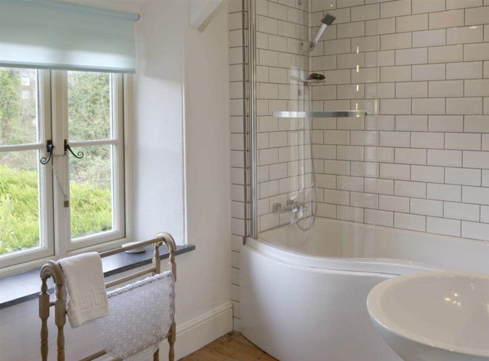 Family bathroom with shower over bath at Ivy Cottage in Boscastle, Cornwall., Great Britain