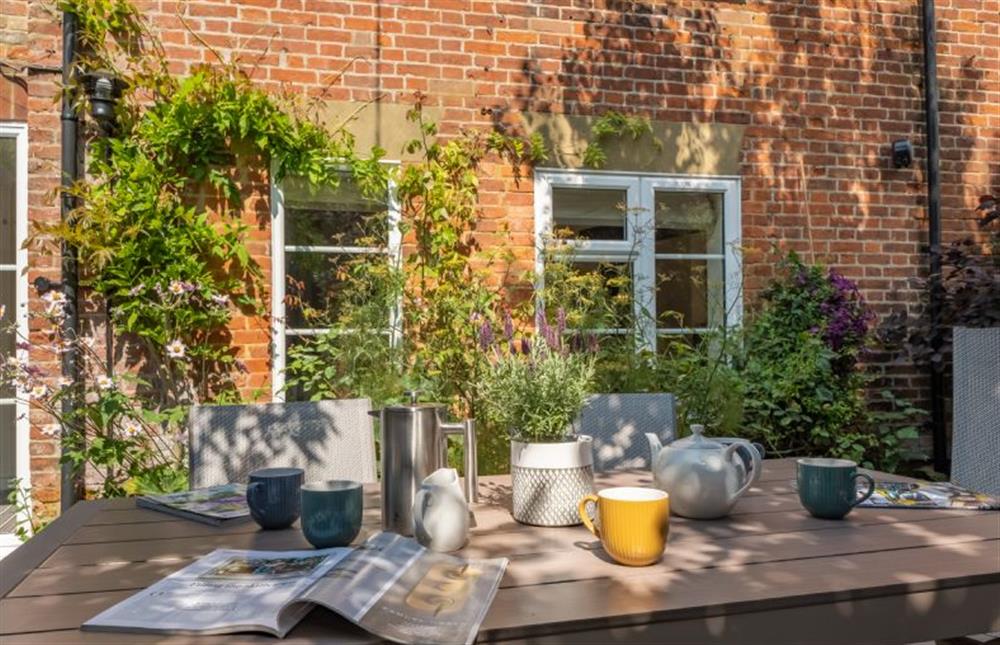 Outside: Sunny courtyard ideal for al fresco dining (photo 2) at Ivy Cottage, Docking near Kings Lynn