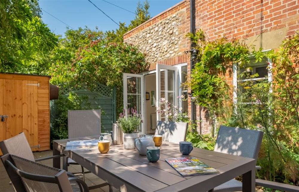 Outside: Sunny courtyard ideal for al fresco dining at Ivy Cottage, Docking near Kings Lynn