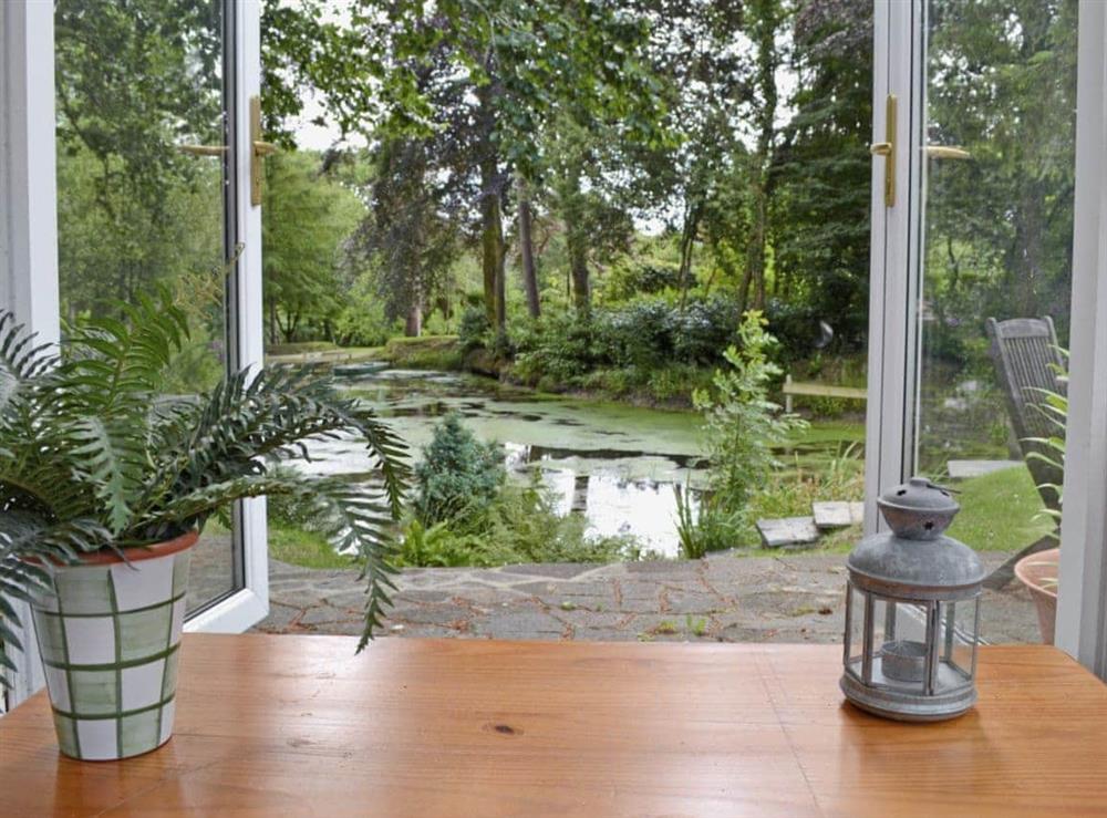 Sun room with lake view at Ivy Cottage in Drefach Felindre, near Newcastle Emlyn, Dyfed