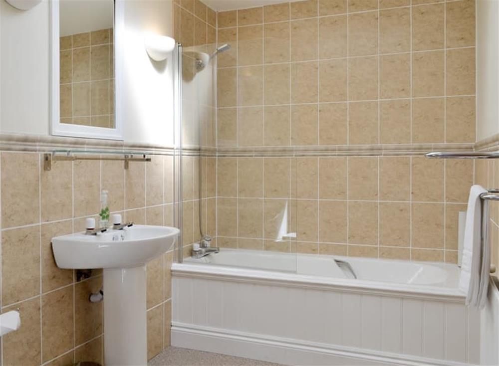En-suite bathroom with shower over bath at Ivy Cottage in Kilcreggan, near Helensburgh, Dumbartonshire