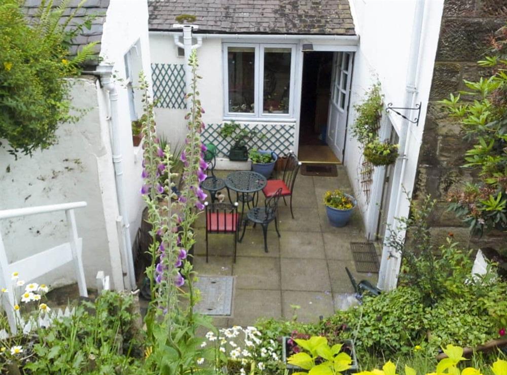 Small patio with garden furniture at Ivybank Cottage in Lamlash, Isle of Arran, Isle Of Arran