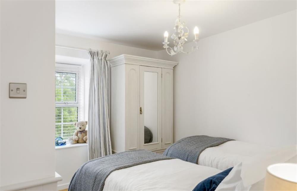 Bedroom one with 3’ twin single beds at Jade Cottage, St Agnes