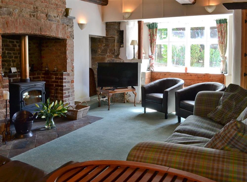 Cosy living room with wood burner (photo 2) at Jalna in Stratton, near Bude, Cornwall