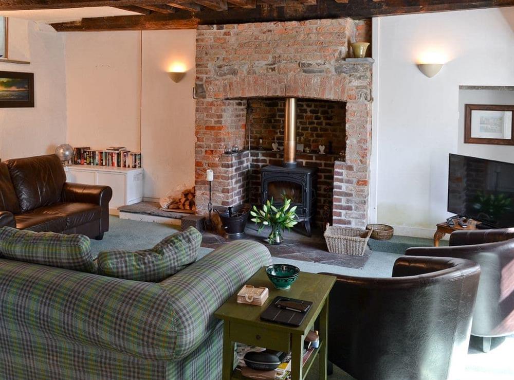 Cosy living room with wood burner at Jalna in Stratton, near Bude, Cornwall
