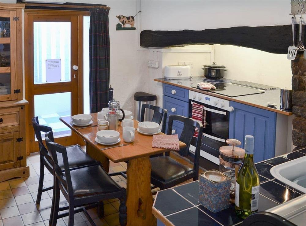 Kitchen with dining table at Jalna in Stratton, near Bude, Cornwall
