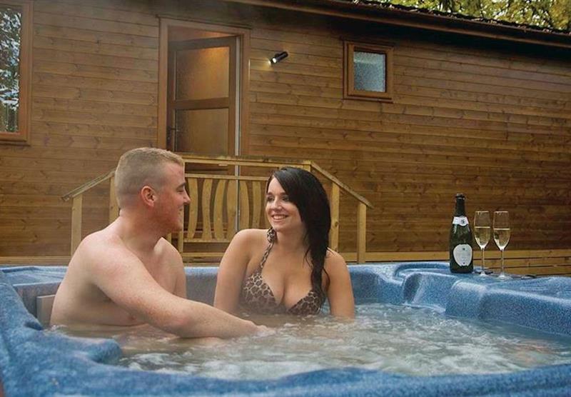 relax in the hot tub at Sandstone Lodge at Jamies Cragg Holiday Park in Welburn, Vale of York