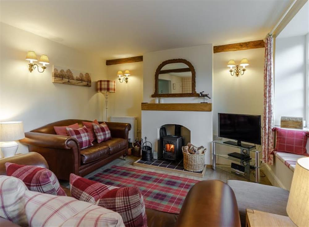 Cosy living room with wood burner (photo 2) at Jasmine Cottage in Bourton-on-the-Water, Gloucestershire