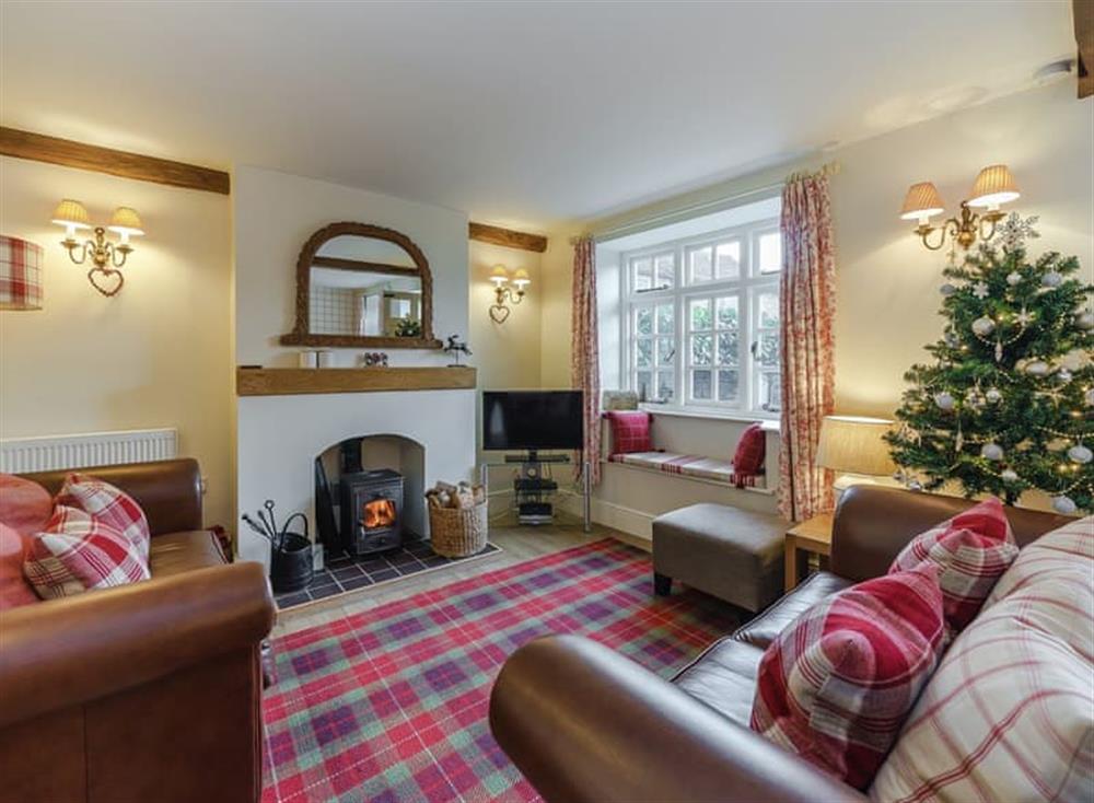 Cosy living room with wood burner at Jasmine Cottage in Bourton-on-the-Water, Gloucestershire