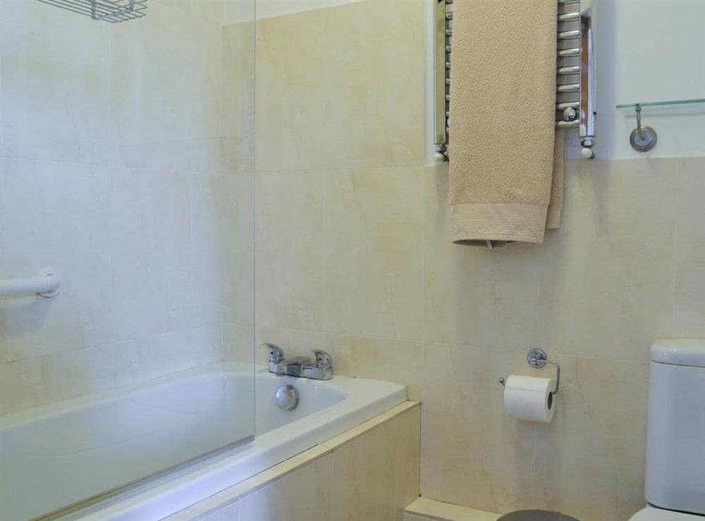 En-suite bathroom with shower over bath at Jasmine Cottage in Consett, near Durham, County Durham, England
