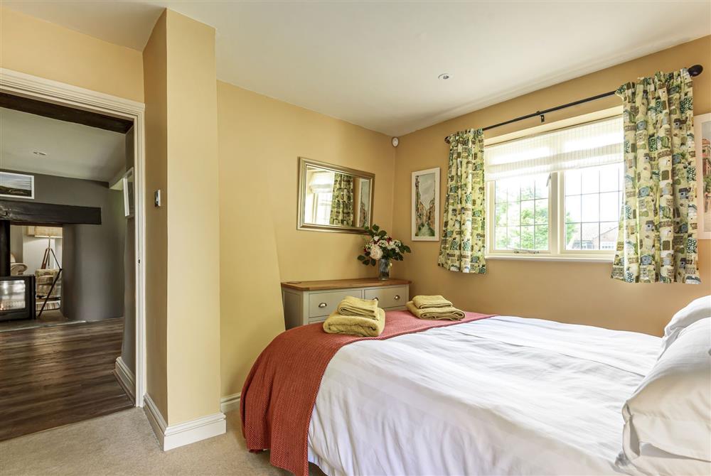 The bedroom leading through to the kitchen and dining area at Jasmine Cottage, Shaftesbury