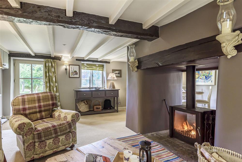 The cosy sitting room with wood burning stove at Jasmine Cottage, Shaftesbury