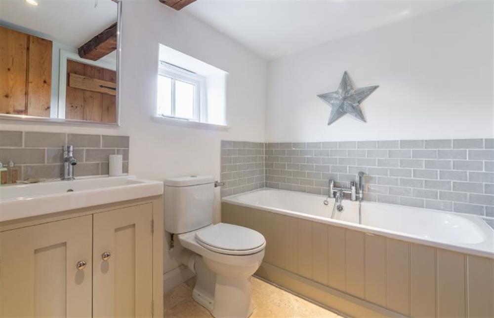 First floor: Family bathroom has hand-held shower at Jasmine Cottage, South Creake near Fakenham
