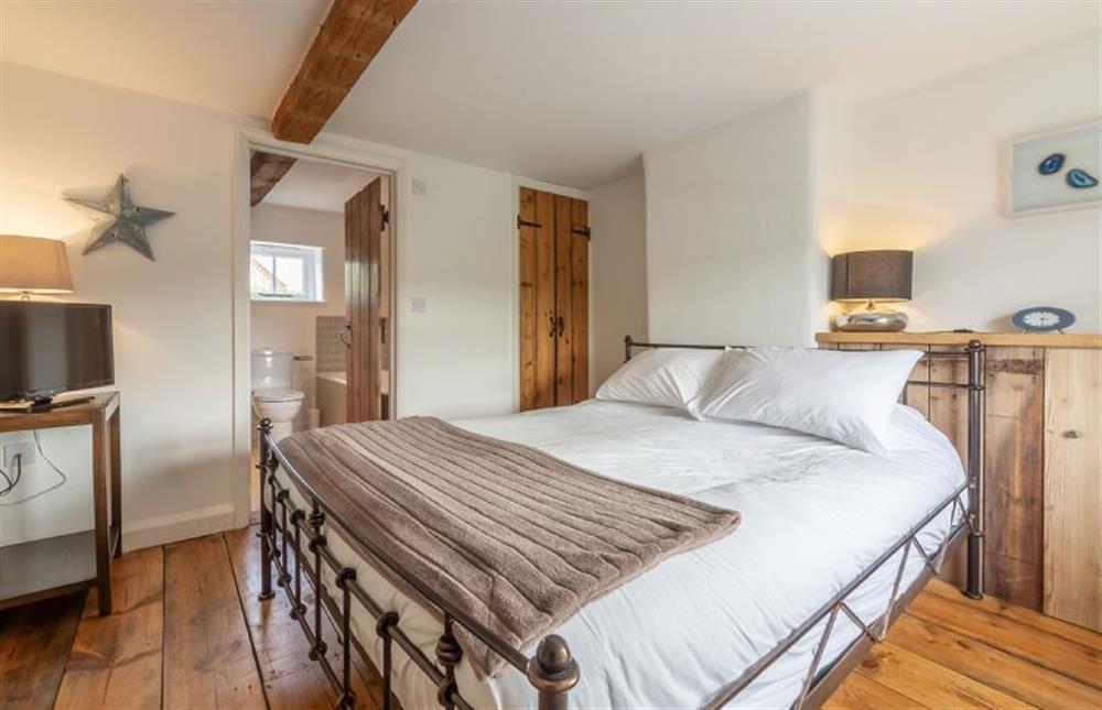 First floor: Master bedroom has king-size bed at Jasmine Cottage, South Creake near Fakenham