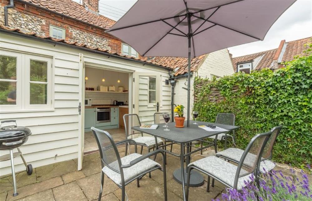 The patio has seating and barbecue at Jasmine Cottage, South Creake near Fakenham