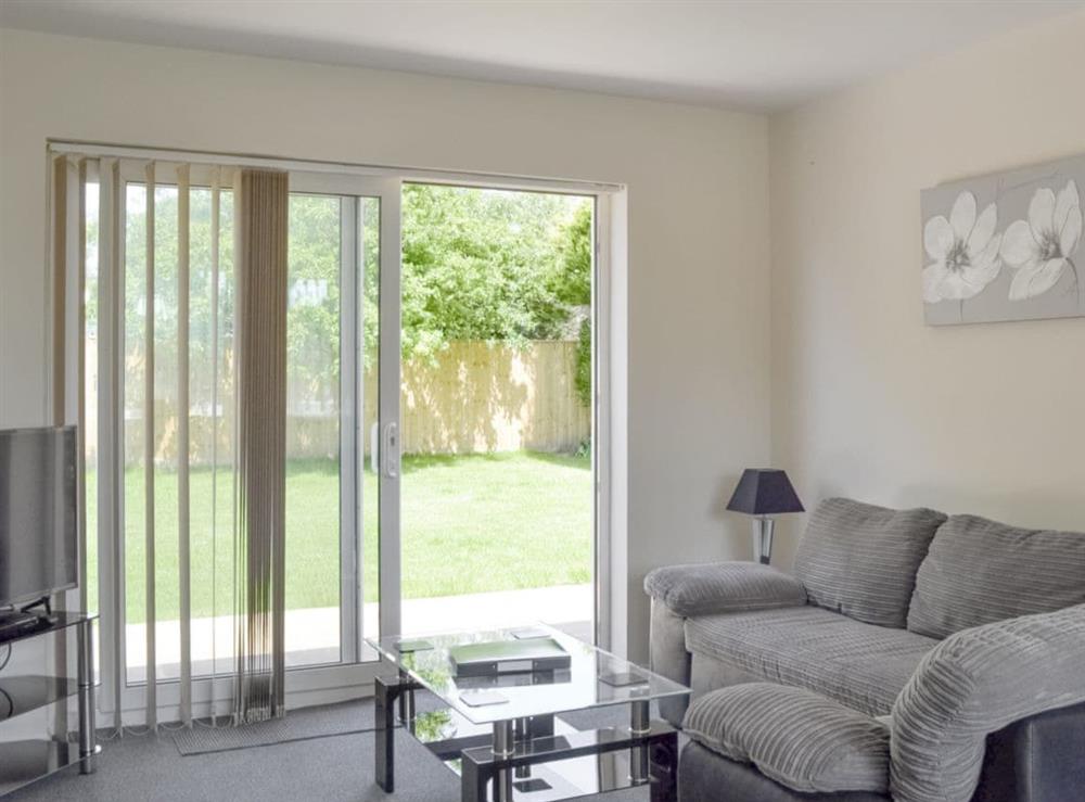 Stylish living area with patio door to garden at Jasper in Broadstone, near Bournemouth, Dorset