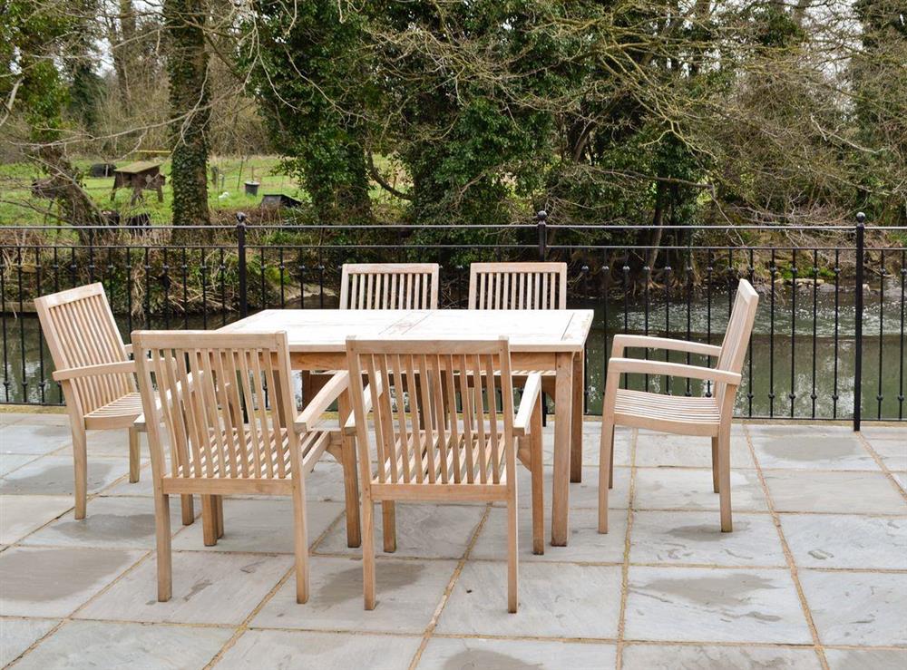 Chairs and table provided for sitting out on the terrace at Herons Weir, 