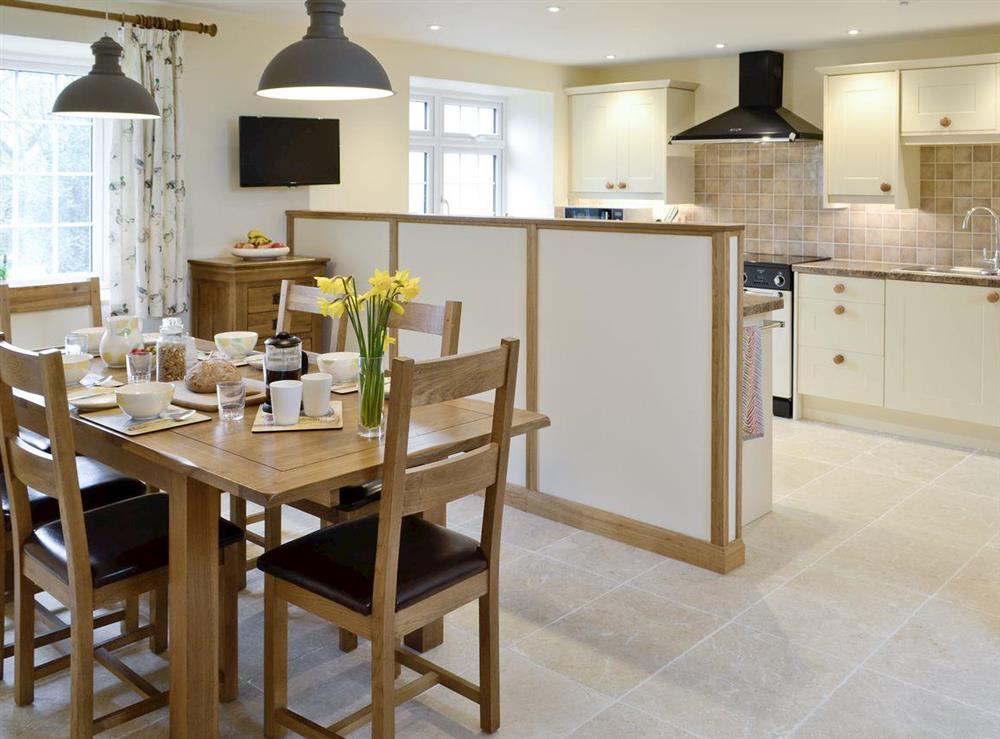 Dining area conveniently situated adjacent to kitchen at Herons Weir, 