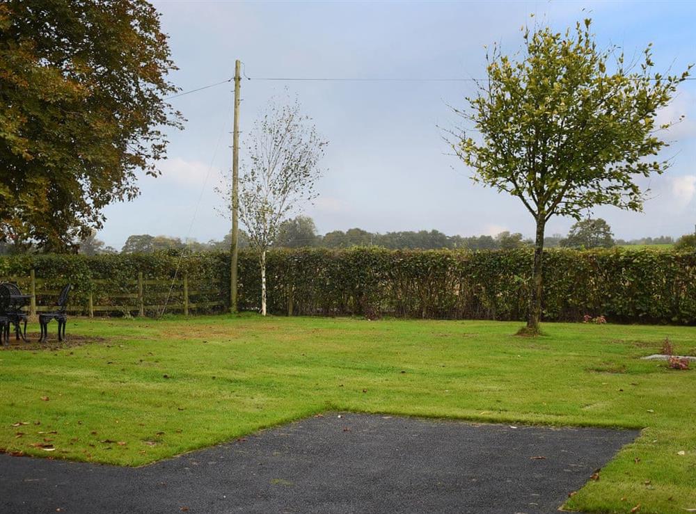 Large lawned area overlooking the adjacent fields and woodland