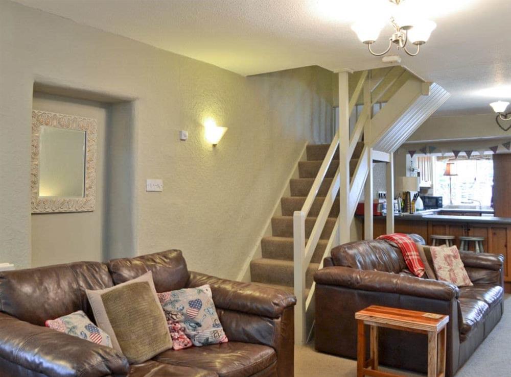 Comfy seating in lounge and stairs to upper level at Jessamy Cottage in Bowness-on-Windermere, Cumbria