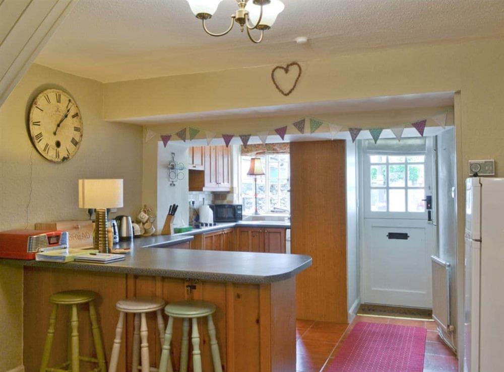 Well equipped kitchen with breakfast bar at Jessamy Cottage in Bowness-on-Windermere, Cumbria