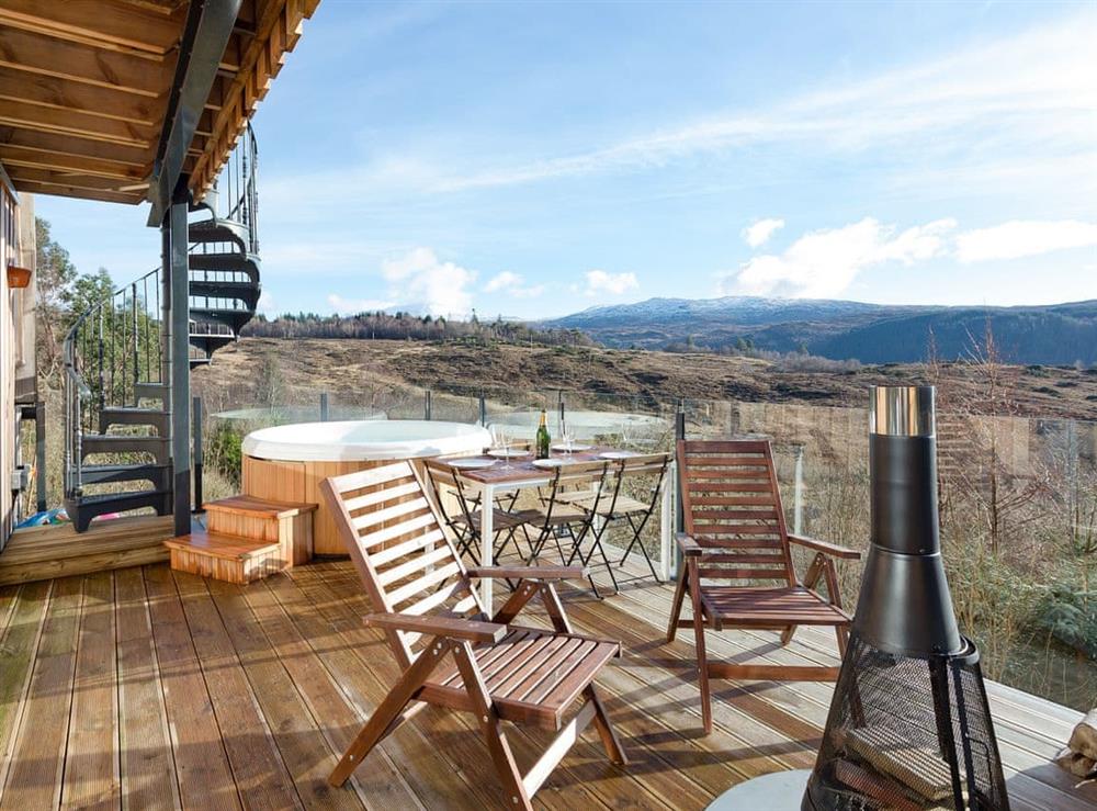 Ideal decking area with hot tub, dining area and sitting out area with a chiminea at Jill Strawbale House in Strontian, near Fort William, Highlands, Argyll