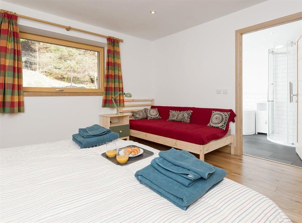 Spacious bedroom with additional seating area and en-suite at Jill Strawbale House in Strontian, near Fort William, Highlands, Argyll
