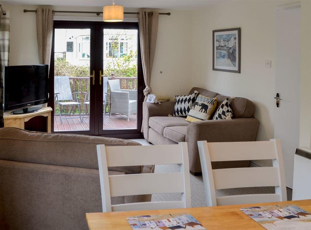 Comfortable living/ dining room at Josnor Chalet in Benllech, Anglesey, Gwynedd