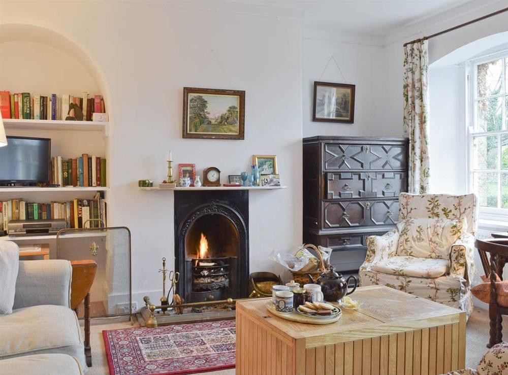 Attractive lounge with open fire at Jubilee Cottage in Church Enstone, near Chipping Norton, Oxfordshire
