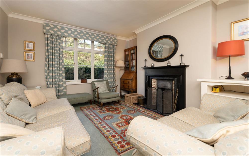 Comfortable lounge with traditional open fireplace at Jubilee Cottage in Thurlestone