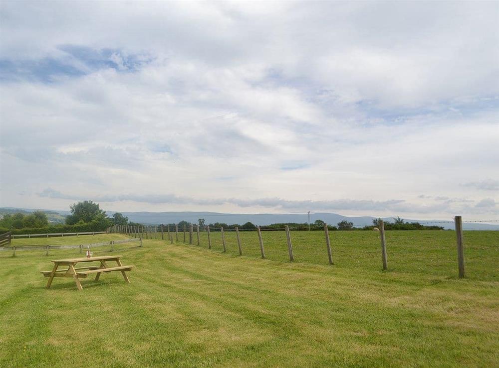 Private grassed area with picnic area at Kaptains Cabin in Yanwath, near Penrith, Cumbria