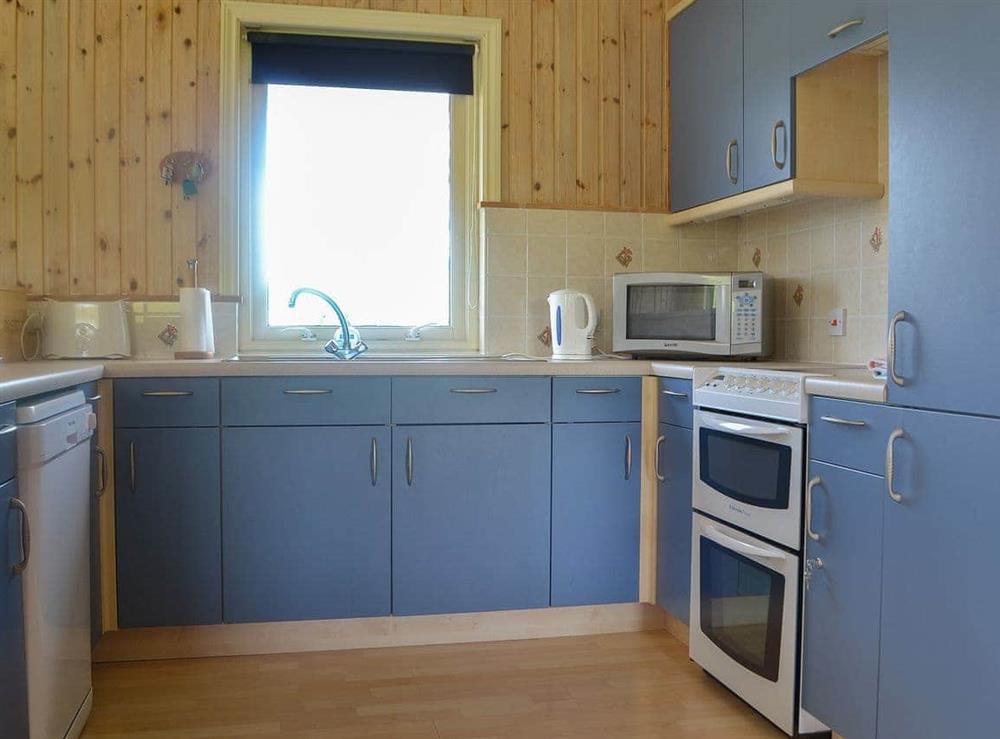 Well-fitted and equipped kitchen area at Kaptains Cabin in Yanwath, near Penrith, Cumbria