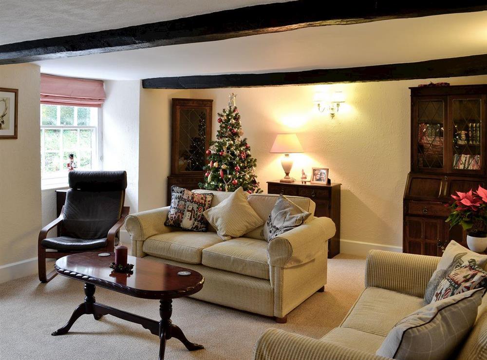 Living room with festive decorations at Karslake House in Winsford, near Dulverton, Somerset