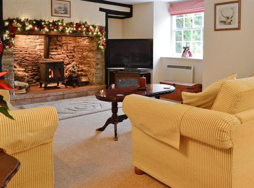 Living room with inglenook fireplace & wood burning stove at Karslake House in Winsford, near Dulverton, Somerset