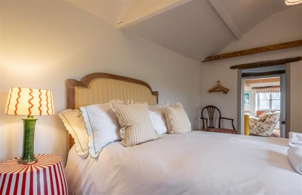 Bedroom one with a 5’ king-size bed  at Keepers Cottage, Aylsham