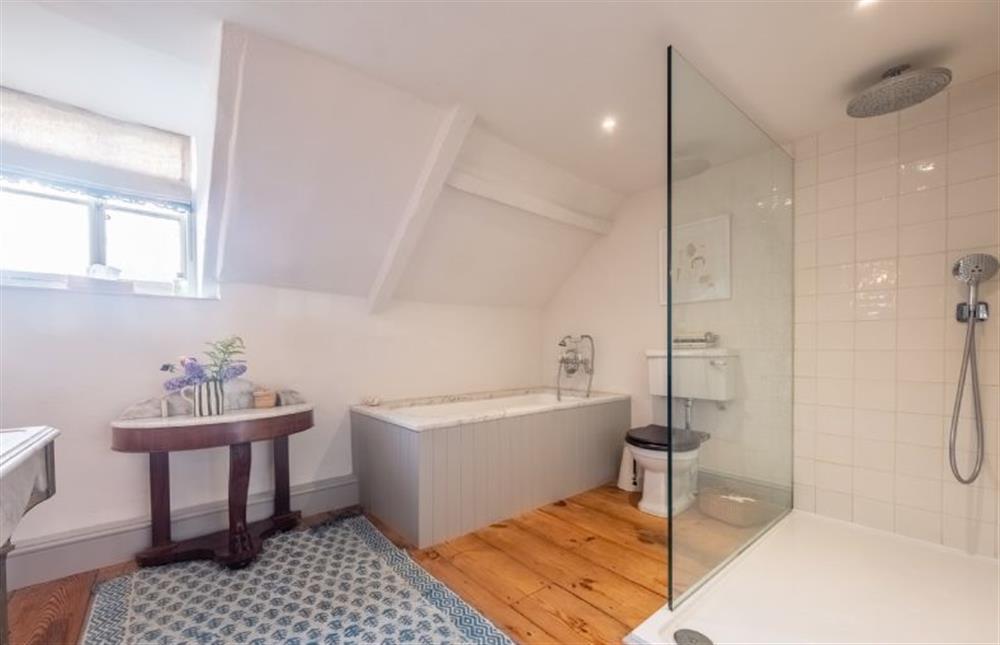 The first family bathroom with bath and separate walk-in shower  at Keepers Cottage, Aylsham