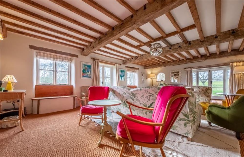 The sitting room boasts exposed beams