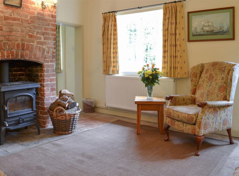 Charming living room with wood burner snd feature fireplace at Keepers Cottage in East Beckham, near Sheringham, Norfolk