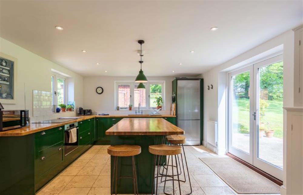 The modern bespoke kitchen with french doors to the garden at Keepers Cottage, Fring near Kings Lynn