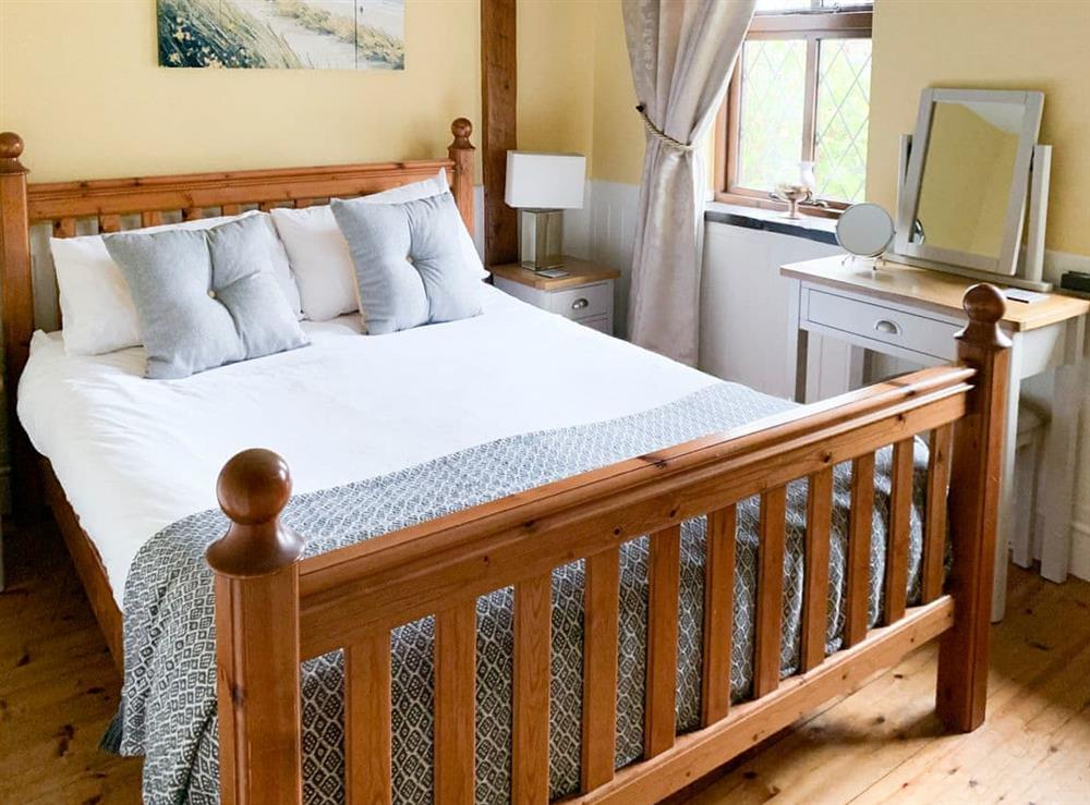 Kingsize Bedroom with walk in wardrobe and ensuite at Keepers Cottage in Red Wharf Bay, Anglesey, Gwynedd