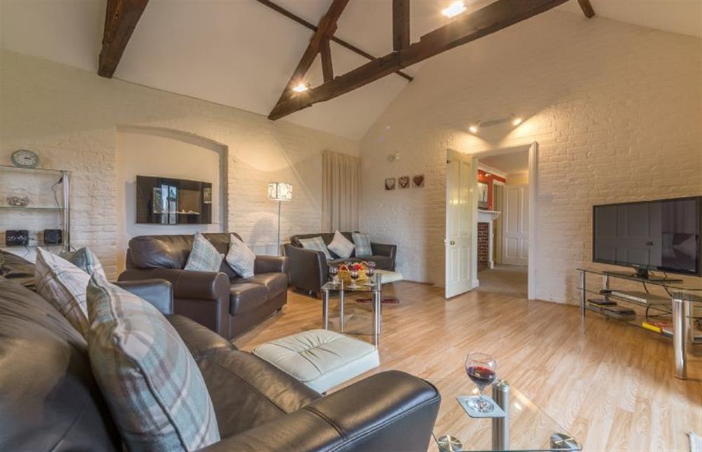 Ground floor: Spacious room with comfortable sofas and large television at Keepers Cottage, West Barsham near Fakenham