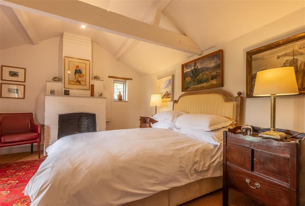 Bedroom one with a 6’ super-king size bed at Keepers Cottage, Wolterton