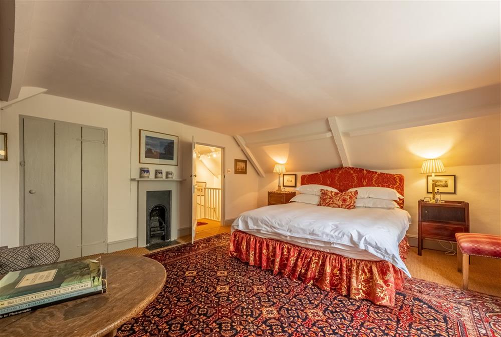 Bedroom two with a 6’ super-king size bed and walk-in wardrobe at Keepers Cottage, Wolterton