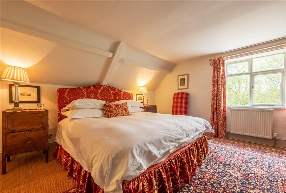 Bedroom two with a 6’ super-king size bed with views of the outstanding parkland at Keepers Cottage, Wolterton